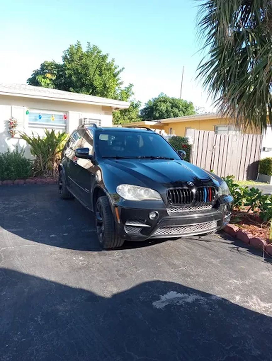 Black BMW SUV parked in a driveway