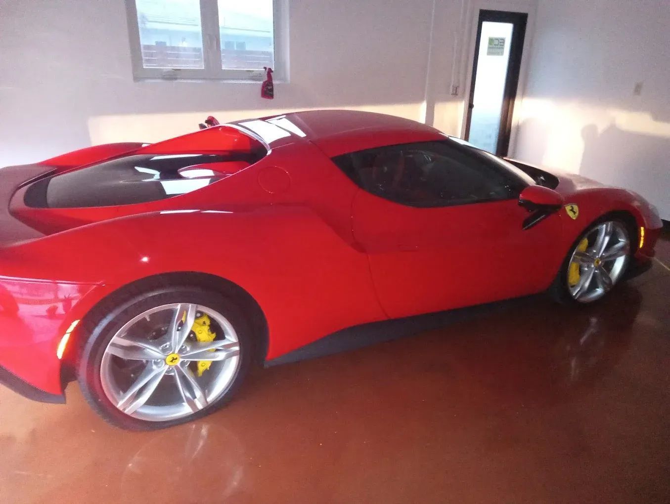Red Ferrari parked indoors