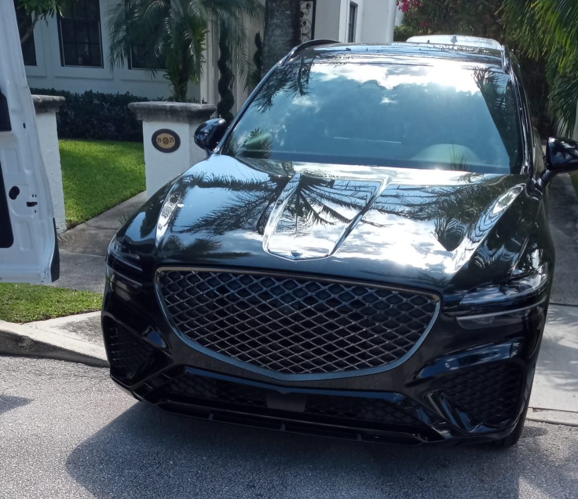 Black Genesis SUV parked in a driveway