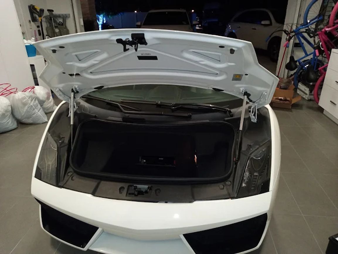 White Lamborghini with the front trunk open