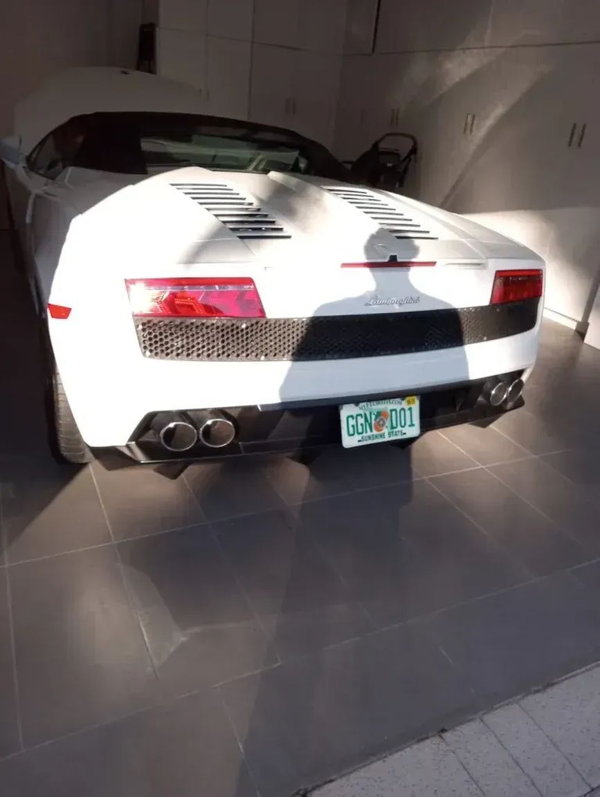 White Lamborghini convertible in a garage
