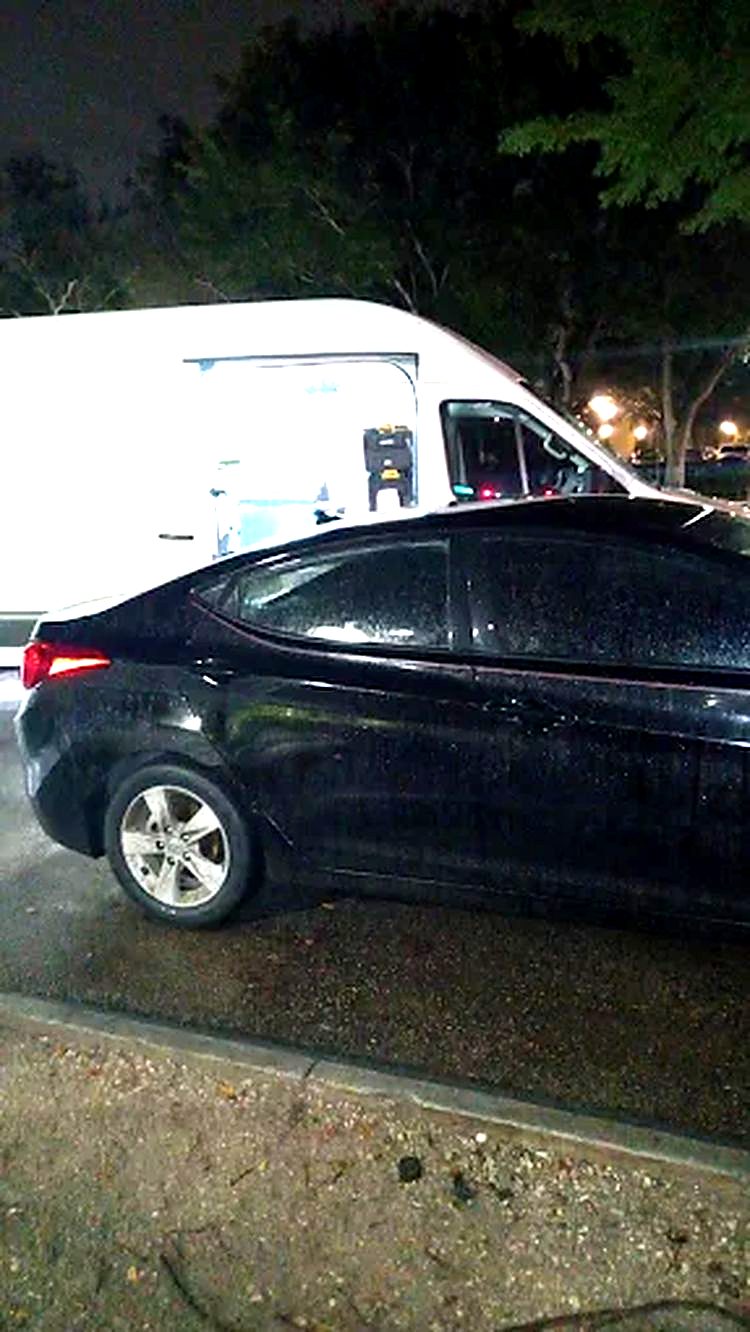 Service van parked beside a black sedan on a night call