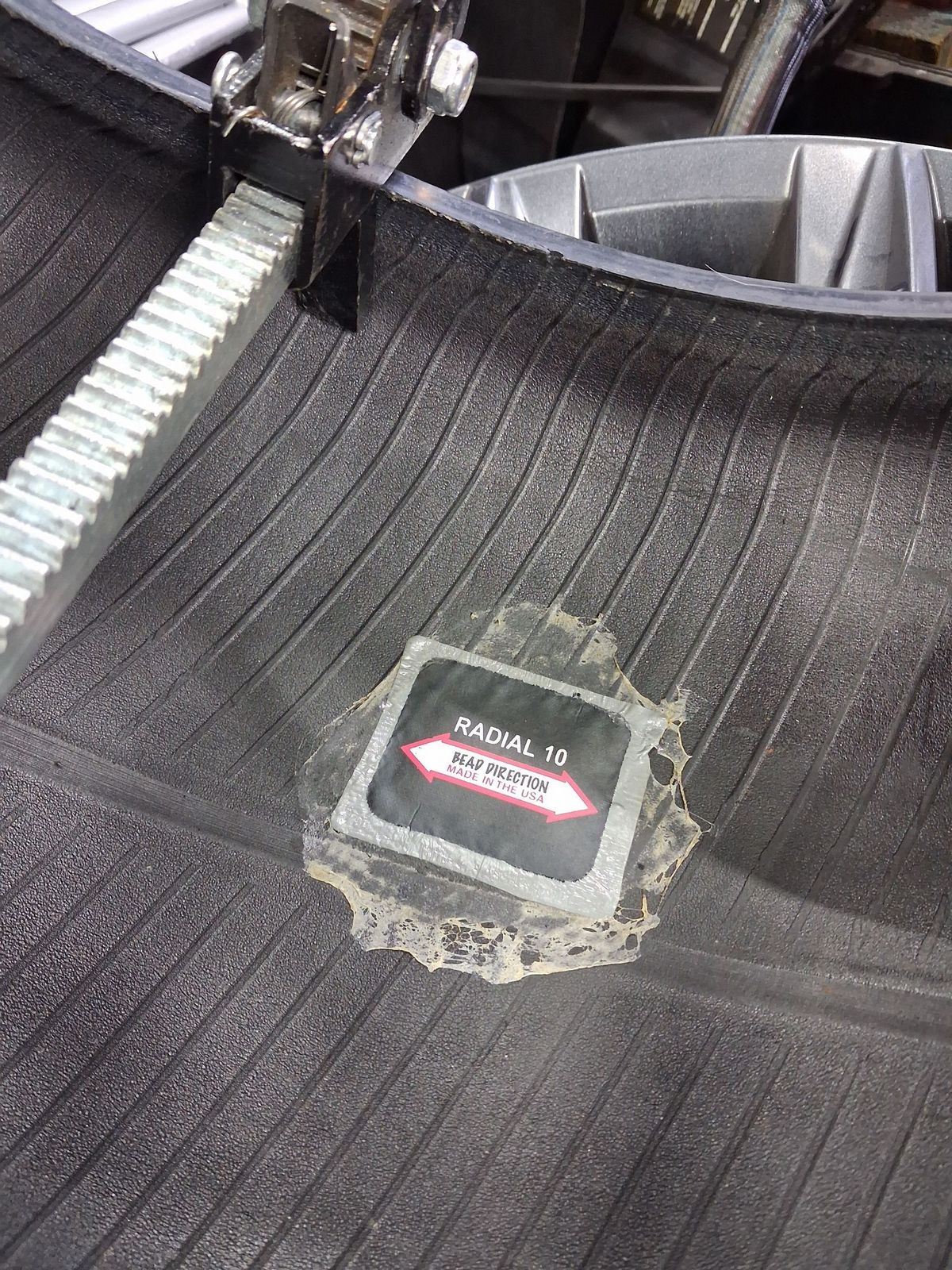 Inside of a tire with a fresh patch, on a tire machine