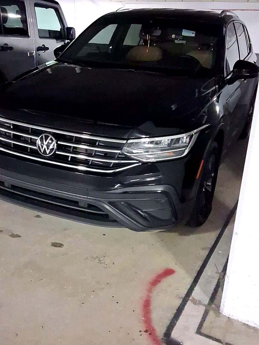 Black Volkswagen SUV in a parking garage