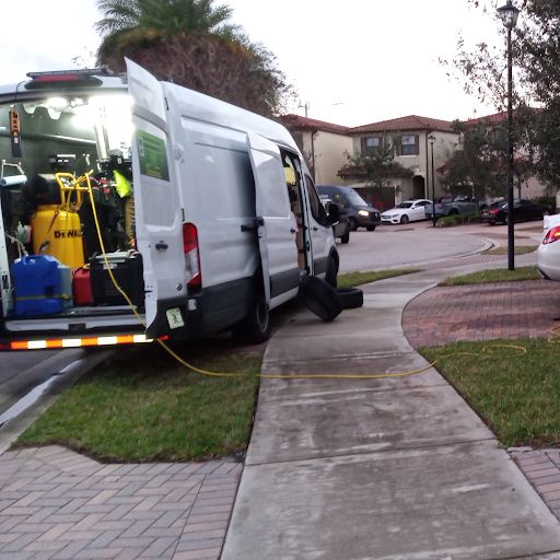 Service van with its side and back doors open, tools and equipment inside