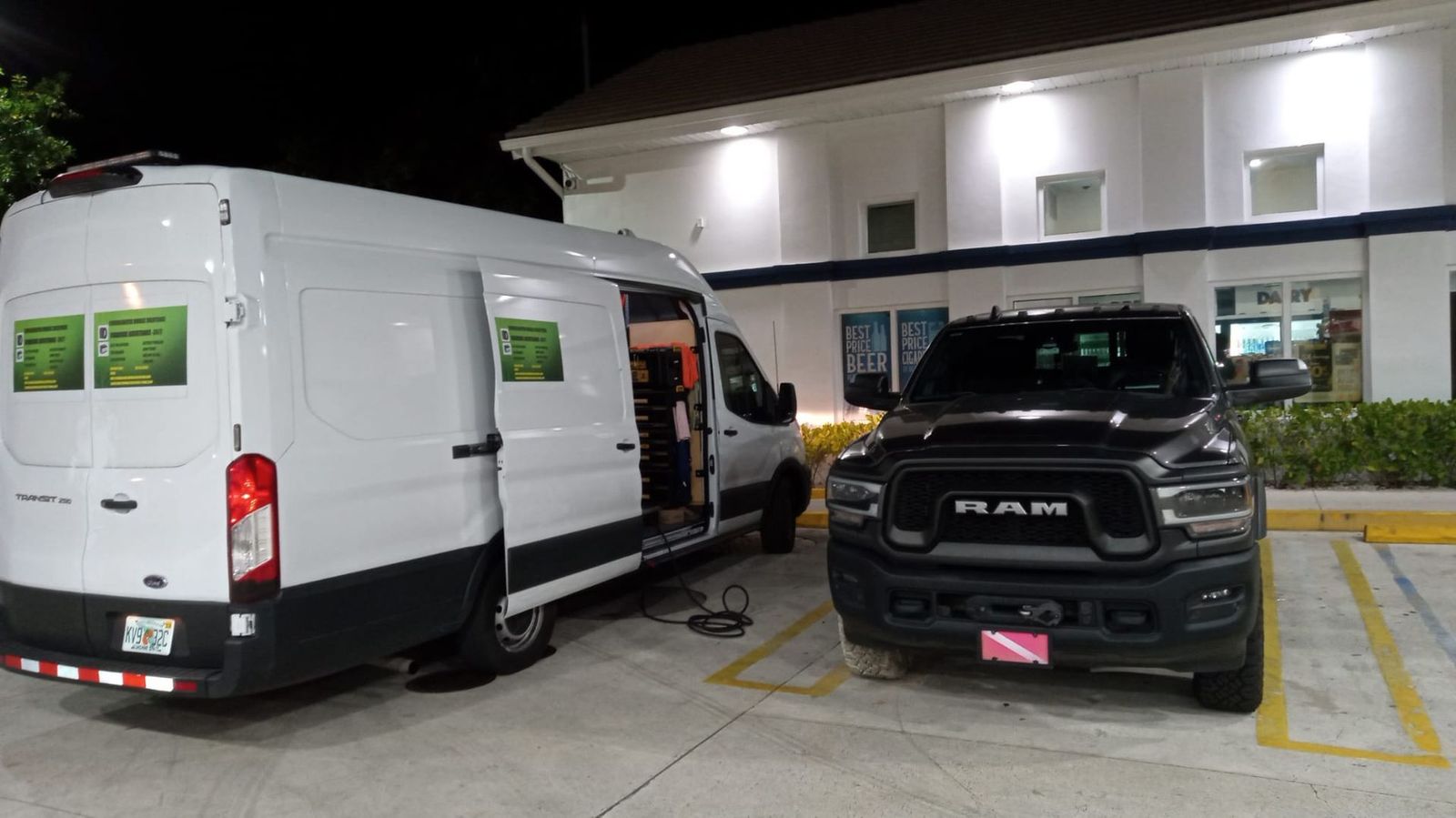 White service van parked next to a black Ram pickup