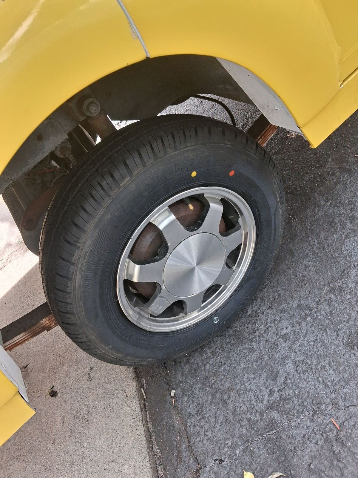 Close view of a wheel and tire on a yellow car