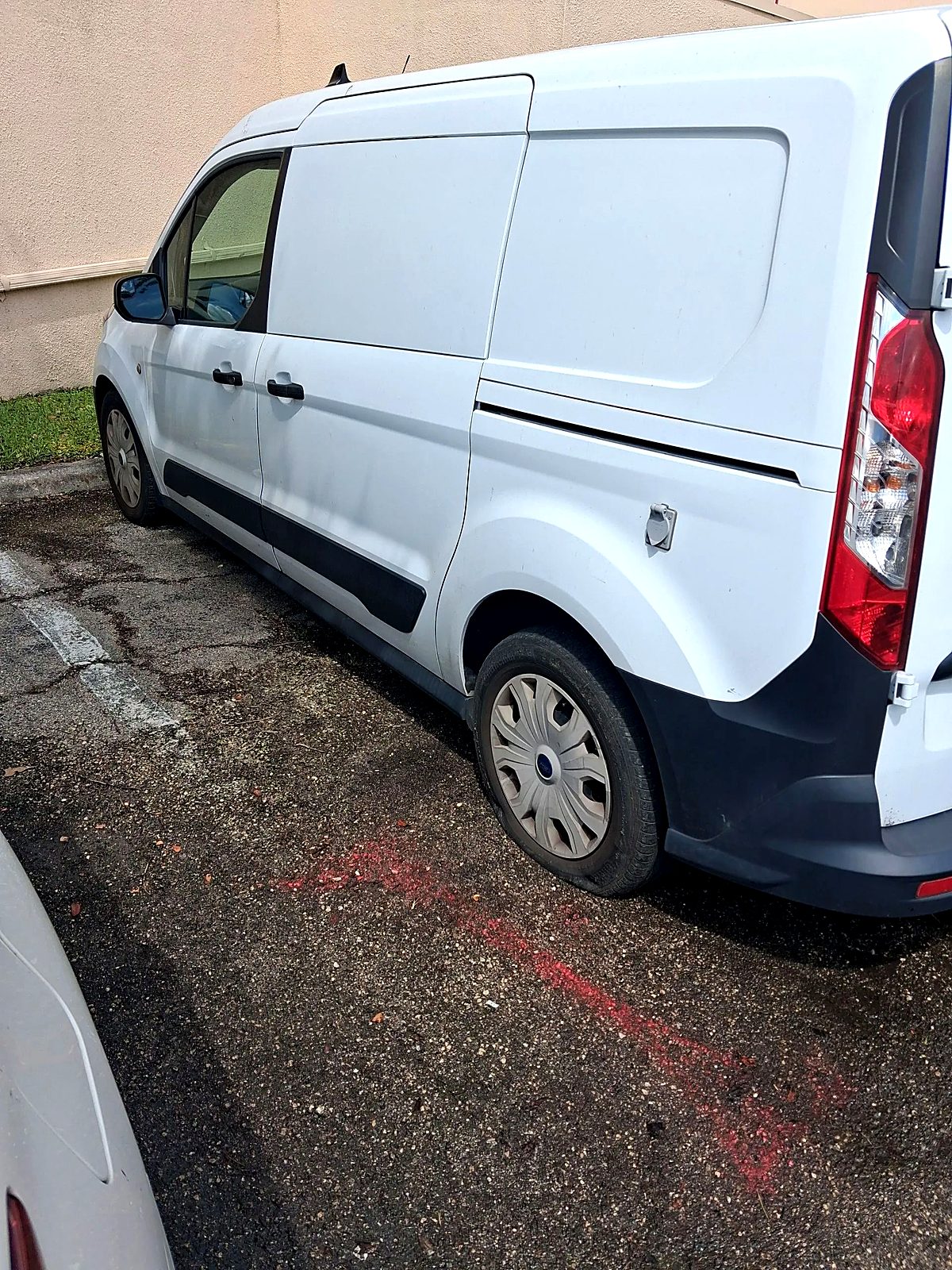 White cargo van parked on a driveway